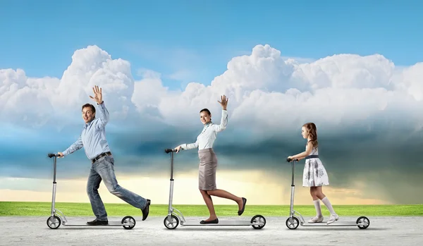 Happy family riding on scooter — Stock Photo, Image