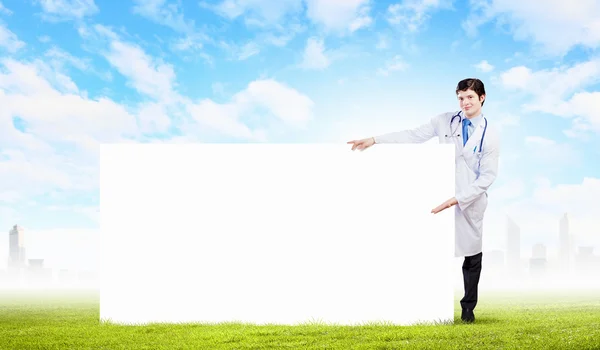 Male doctor with banner — Stock Photo, Image