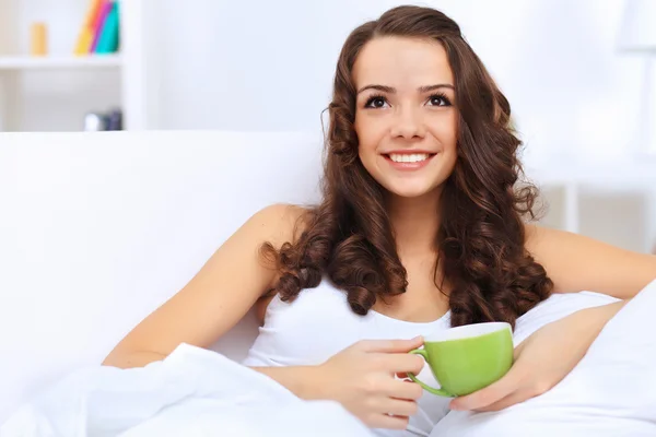 Young woman having cup of tea at home — Stock Photo, Image