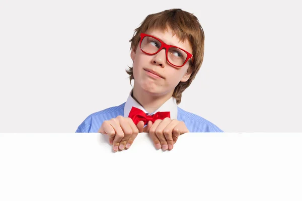 Boy in red glasses holding white square — Stock Photo, Image