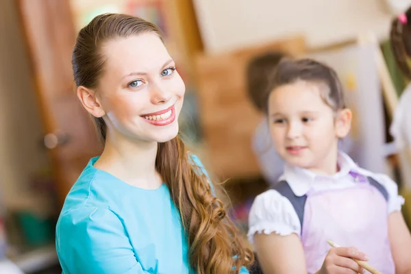 Cute girl and teacher — Stock Photo, Image