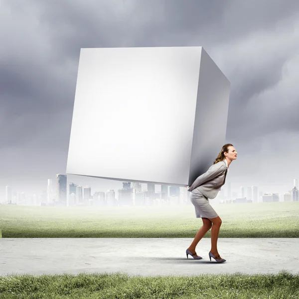 Businesswoman carrying cube — Stock Photo, Image