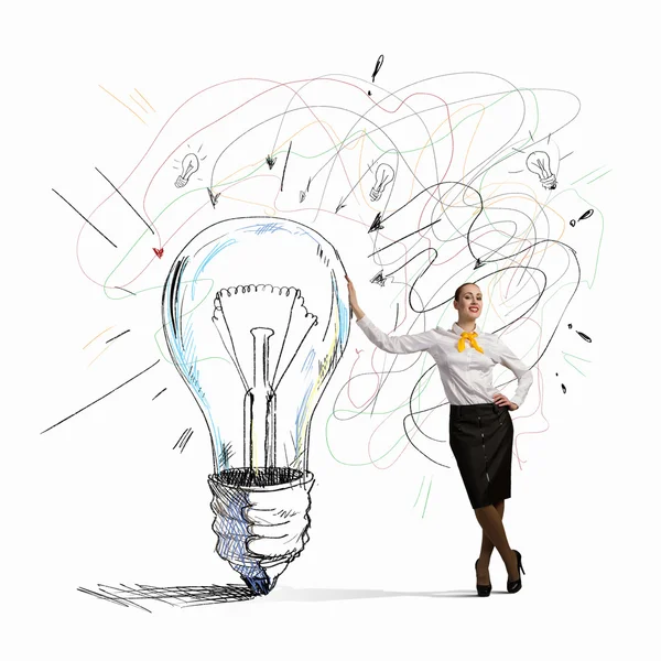 Businesswoman leaning on bulb Stock Image
