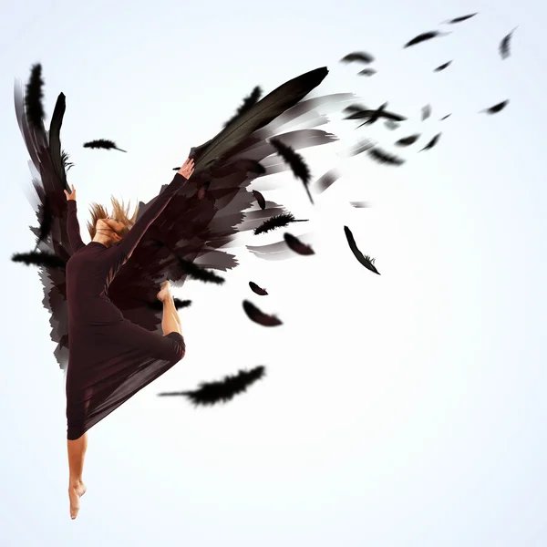 Woman floating on dark wings — Stock Photo, Image