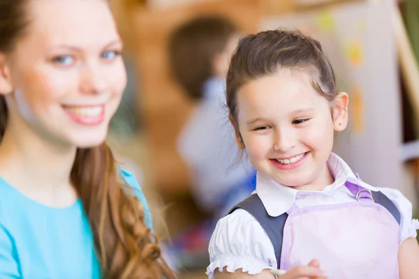 Cute girl and teacher — Stock Photo, Image