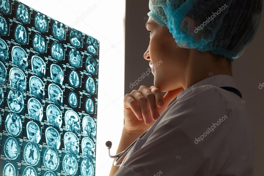 Woman doctor examining x-ray