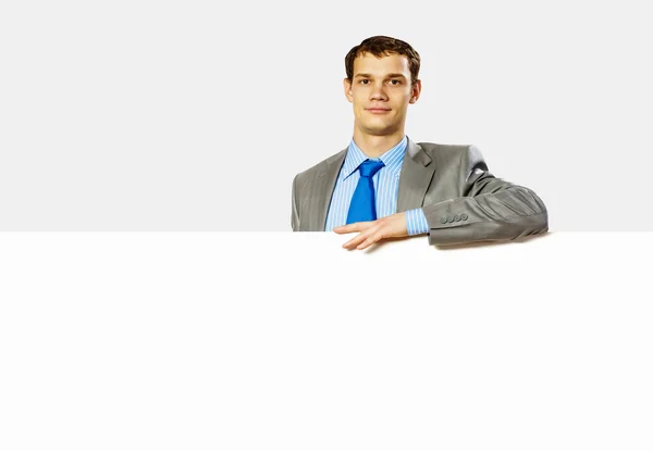 Businessman holding blank banner — Stock Photo, Image