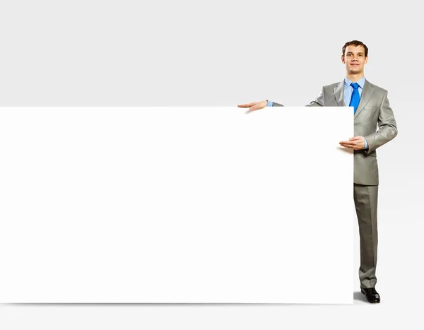 Businessman holding blank banner — Stock Photo, Image