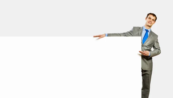 Businessman holding blank banner — Stock Photo, Image