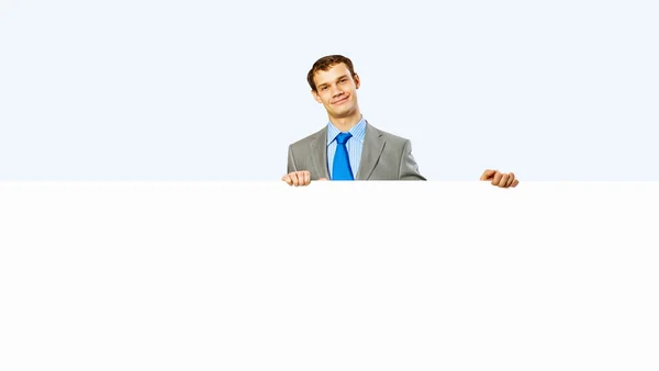 Businessman holding blank banner — Stock Photo, Image