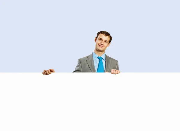 Businessman holding blank banner — Stock Photo, Image