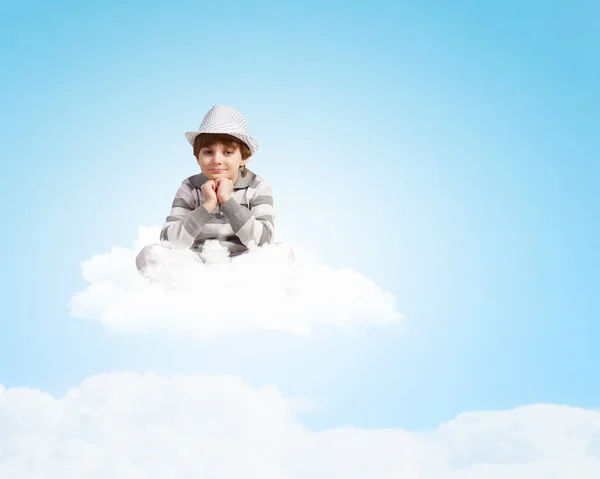 Boy sitting on cloud — Stock Photo, Image