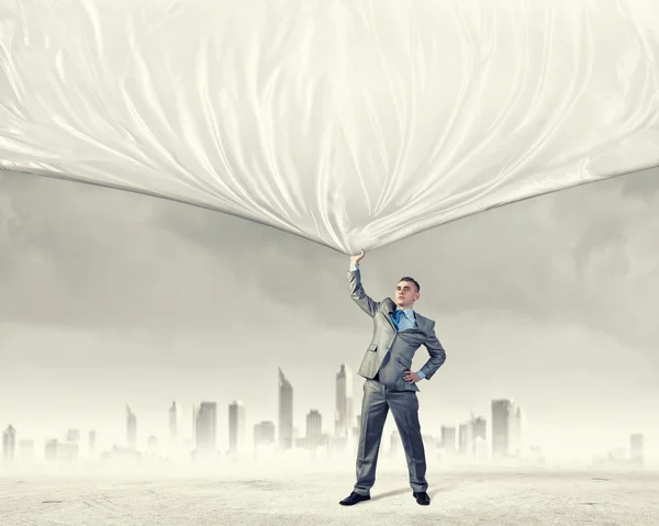 Young man pulling banner — Stock Photo, Image