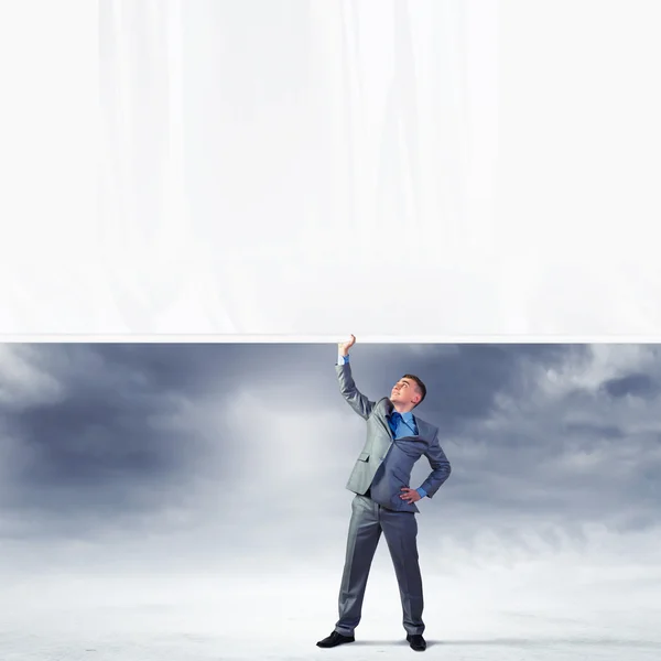 Young man pulling banner — Stock Photo, Image