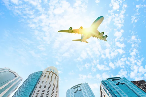 Airplane above city — Stock Photo, Image