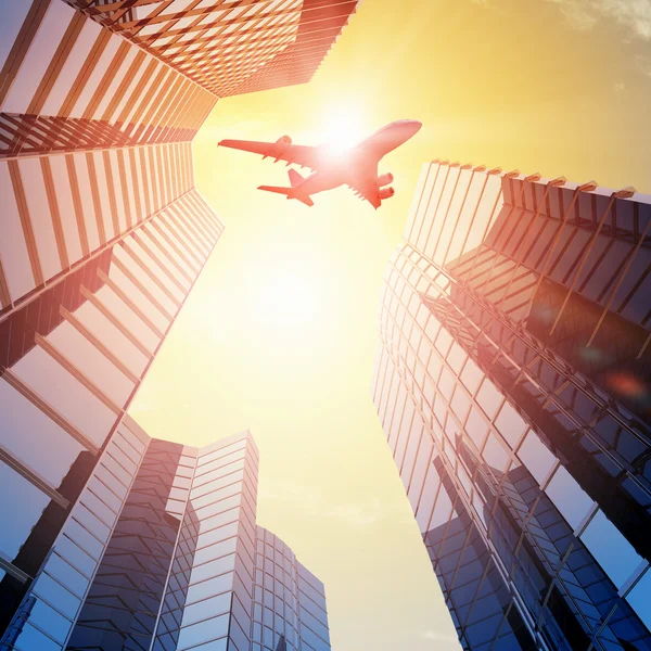 Airplane above city — Stock Photo, Image