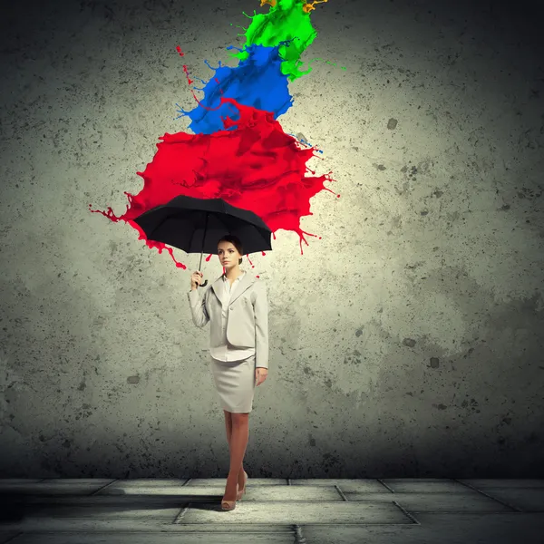 Young business woman holding an umbrella — Stock Photo, Image