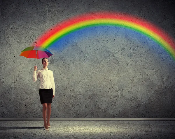 Young business woman holding an umbrella — Stock Photo, Image