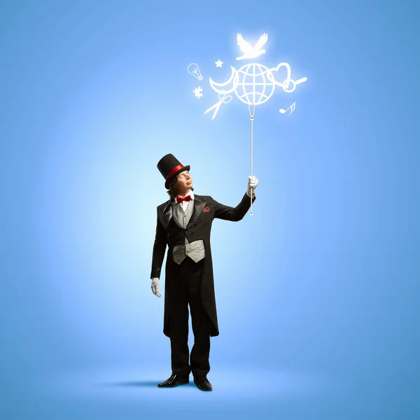 Magician with globe Stock Image