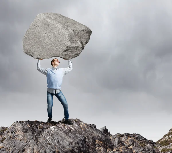 Guy lifting stone — Stock Photo, Image