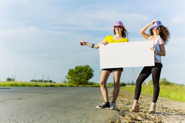 Two girls with banner — Stock Photo, Image