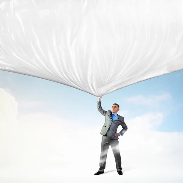 Young man pulling banner — Stock Photo, Image