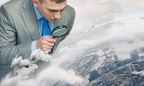 Man looking in magnifier — Stock Photo, Image