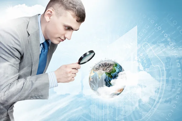 Man looking in magnifier — Stock Photo, Image