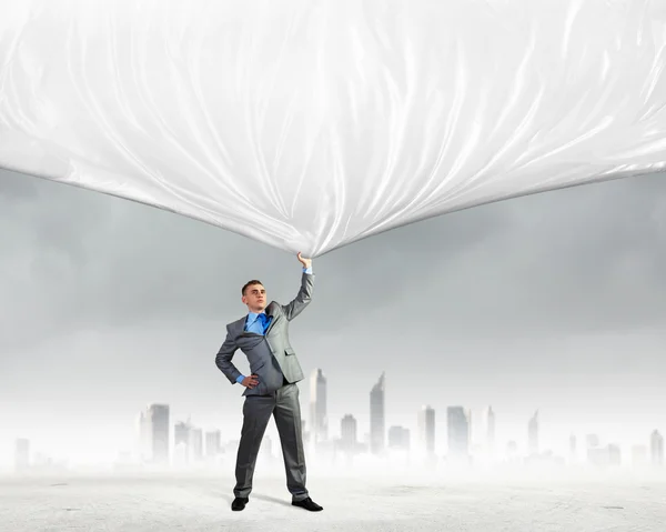 Young man pulling banner — Stock Photo, Image