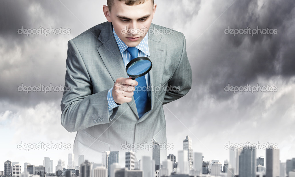 Man looking in magnifier