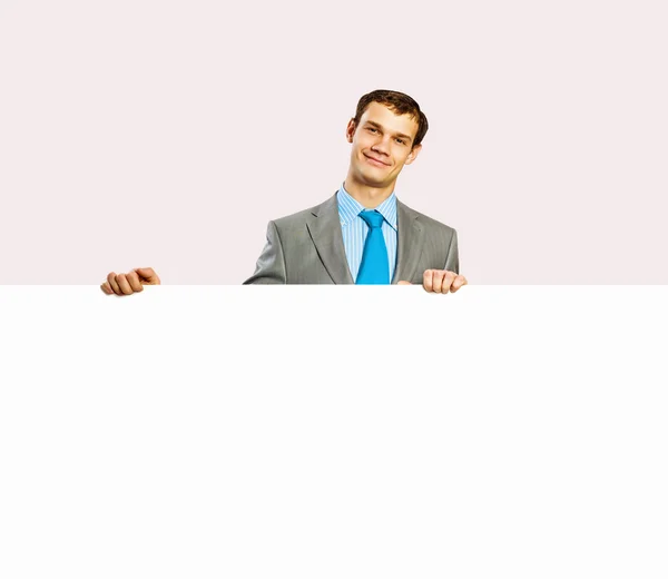 Businessman holding blank banner — Stock Photo, Image