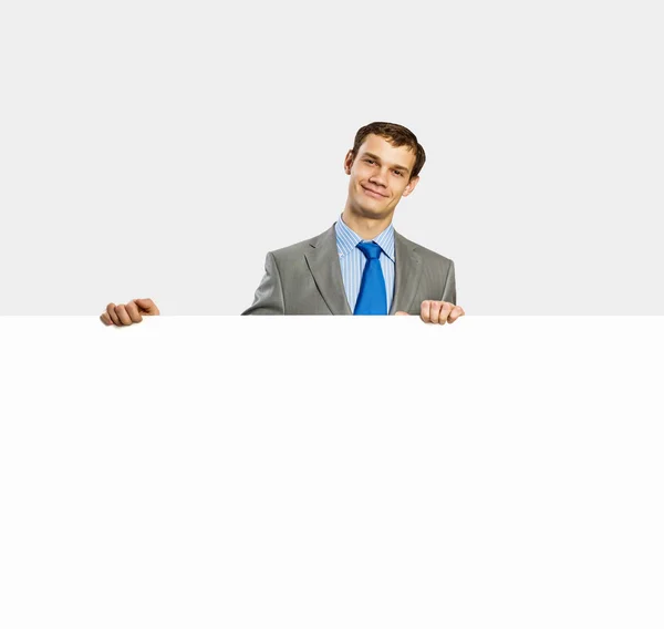 Businessman holding blank banner — Stock Photo, Image