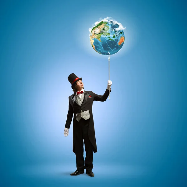 Magician with globe — Stock Photo, Image