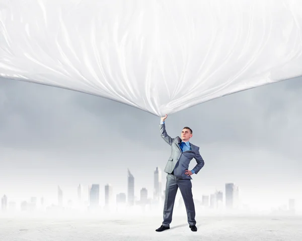 Young man pulling banner — Stock Photo, Image