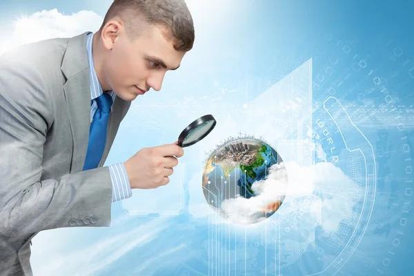 Man looking in magnifier — Stock Photo, Image