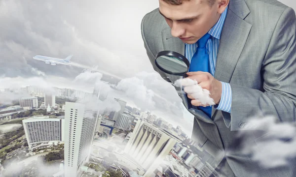 Man looking in magnifier — Stock Photo, Image