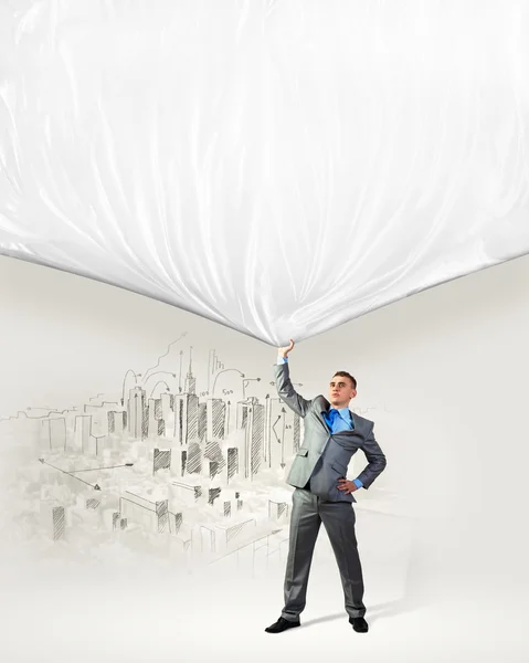 Young man pulling banner — Stock Photo, Image