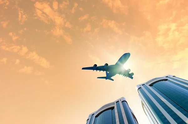 Airplane above city — Stock Photo, Image