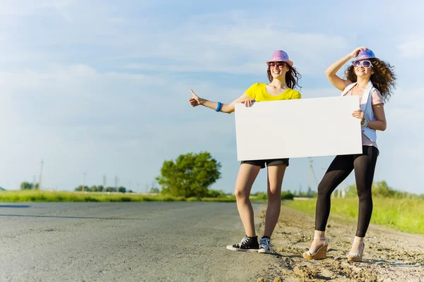 Two girls with banner — Stock Photo, Image