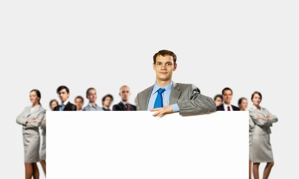 Businessman with blank banner — Stock Photo, Image