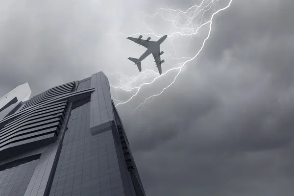 Airplane above city — Stock Photo, Image