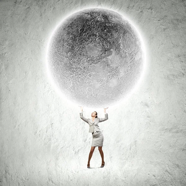 Businesswoman lifting moon — Stock Photo, Image