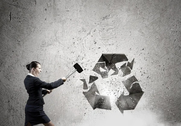 Businesswoman crashing stone recycle symbol — Stock Photo, Image