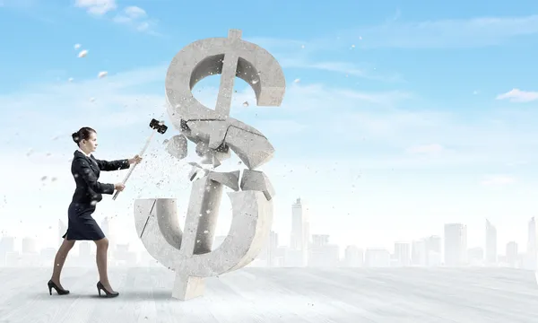 Businesswoman crashing stone dollar symbol — Stock Photo, Image