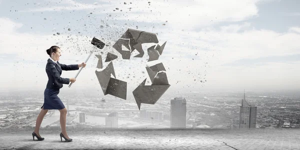 Businesswoman crashing stone recycle symbol — Stock Photo, Image