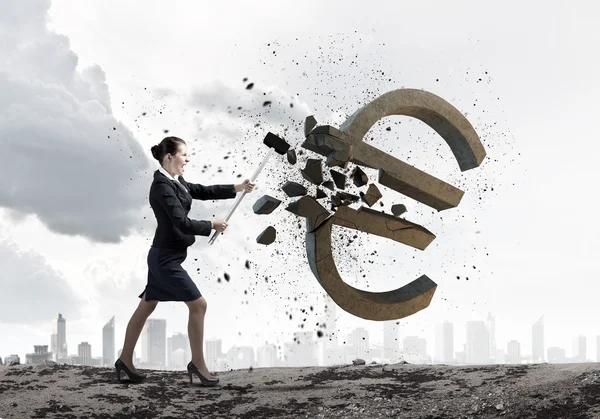 Businesswoman crashing stone euro symbol — Stock Photo, Image