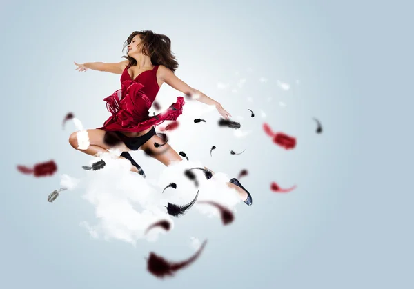 Woman in red dress jumping — Stock Photo, Image