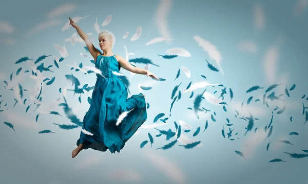 Kvinna i blå klänning hoppning — Stockfoto