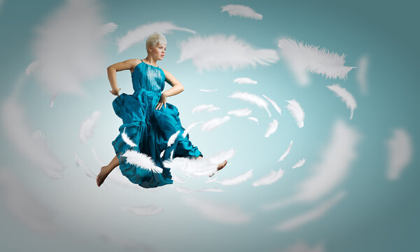 Woman in blue dress jumping