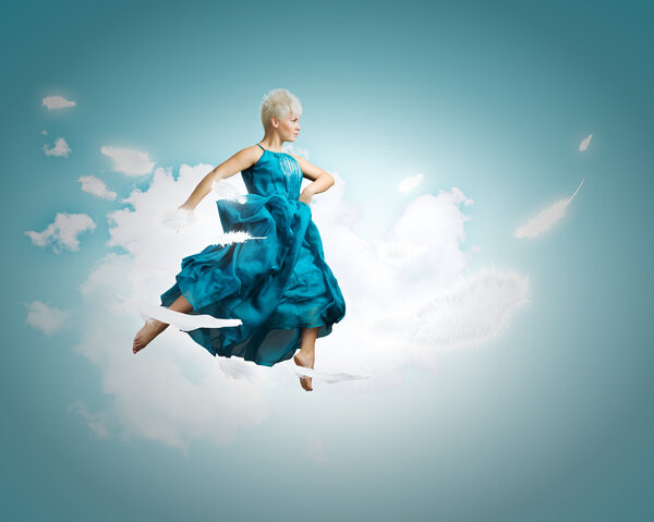 Woman in blue dress jumping